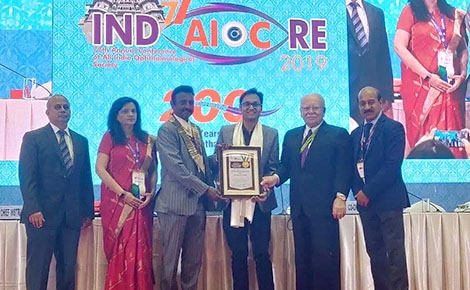 Dr Piyush Tewari being awarded the international heroes award at AIOS Conference